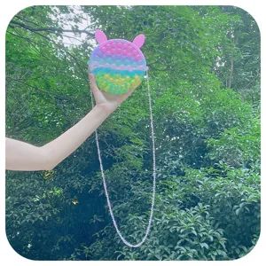 Rainbow silicone push pop bubble sensory toy shoulder bag with cute bunny ears and chain strap.