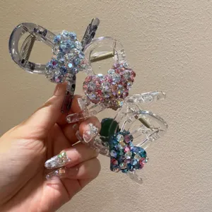 Rhinestone heart hair claw detail showing sparkling crystal embellishments on transparent acrylic shark clip.