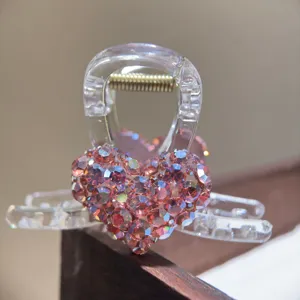 Crystal rhinestone heart hair claw clip for women, sparkling medium acrylic hair accessory.