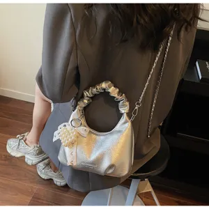 Silver metallic hobo handbag detail, ruched handle, chain strap, pearl pendant.