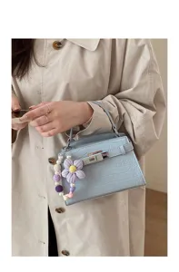Elegant light blue crocodile pattern top handle handbag with cute flower charm detail for women.