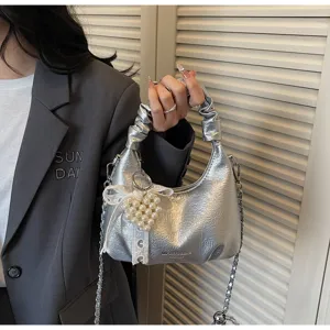 Silver metallic hobo bag for women, chic chain shoulder bag with pearl heart charm.