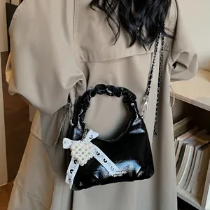 Chic patent leather hobo handbag with chain strap and pearl heart pendant for women.