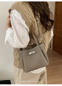 Detailed view of a retro women shoulder bag with elegant turn-lock closure and leather texture.