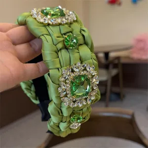 Diadema ancha trenzada de satén verde con brillantes pedrería de cristal relucientes.