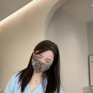 Korean fashion leopard print face mask with rhinestones and butterfly charm for women.