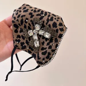 Leopard print rhinestone cross fashion face mask detail showcasing sparkling crystal trim.