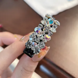 Gros plan détaillé de la pince à cheveux bec de canard en strass étincelants brillants.