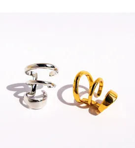 Metal multi-layer spiral C-shape ear cuff, modern non-pierced minimalist ear jewelry detail.
