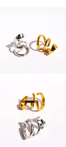 Detail shot of multi-layer spiral C-shaped ear cuffs, metallic style non-pierced stacking clip-on earrings.