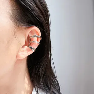 Detailed close-up view of the multi-layer metallic spiral ear cuff worn elegantly.