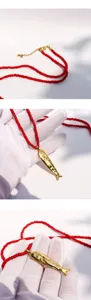 Gold fish pendant red seed bead long necklace artisanal resort style jewelry detail view