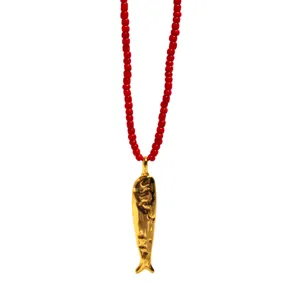 Gold fish pendant necklace with vibrant red rice beads, long bohemian vacation style jewelry.