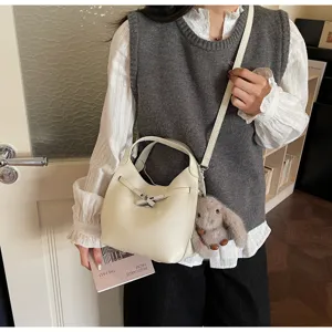 Minimalist winter hobo bucket bag for women, stylish leather shoulder bag detail.