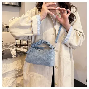Stylish denim shoulder bag for women, chic gathered handle crossbody purse for daily wear.