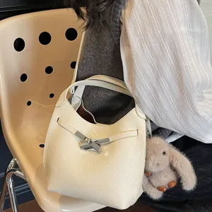 Minimalist leather hobo shoulder bag for women, stylish commuting handbag with metal lock.