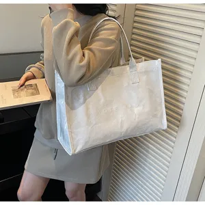 Large capacity translucent tote bag for women, stylish commuting handbag and shoulder bag.