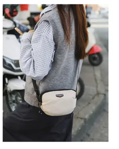 Detailed view of casual outdoor cross-body bag worn by model, perfect for daily use.