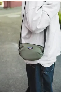 Outdoor small crossbody bag for men and women, casual commuter shoulder bag with zip.