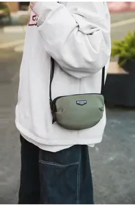 Outdoor small crossbody bag for men and women, casual commuter shoulder phone bag with stylish design.
