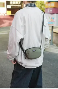 Detail view of outdoor casual crossbody sling bag, olive green, compact phone bag.