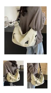 Detailed view of the casual canvas shoulder bag with a small pouch and unique triangle logo.