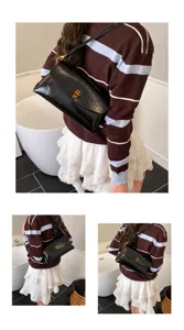 Detailed shot of the stylish black shoulder bag worn by model, showing versatile fashion.