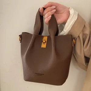 Vintage brown leather bucket bag for women, stylish shoulder handbag with gold hardware.