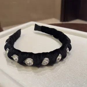 Close-up detail of a black velvet rhinestone headband, elegant and stylish hair accessory.