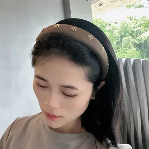 Brown wide headband for women featuring stylish gold cross studs, elegant hair accessory.