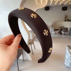 Chic black padded headband with golden cross metal rivets, trendy wide hair hoop for women