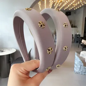 Detailed shot of a wide purple headband featuring stylish metallic cross charms for women.