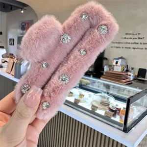 Pink fluffy hair claw clip with sparkling rhinestones, perfect for stylish autumn and winter looks.