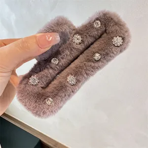 Plush rhinestone hair claw clip detail, fluffy square design for elegant winter hairstyles.
