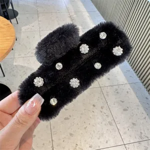Detailed view of black fluffy hair claw clip featuring elegant sparkling rhinestones design.
