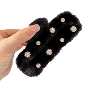 Black plush hair claw clip featuring sparkling rhinestone details, trendy autumn winter hair styling.