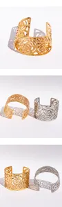 Wide open cuff bracelet with hollow floral design and textured metallic finish for women style.