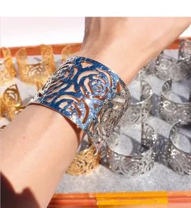 3D hollow floral wide cuff bracelet, metallic open bangle, exaggerated statement wrist jewelry.