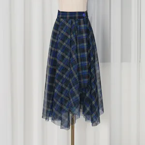 Detail view of the blue plaid mesh skirt showing the asymmetric hem and high-waisted design.