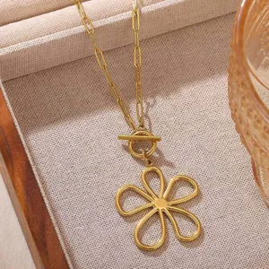 Detailed close-up view of a chic gold flower pendant necklace featuring a stylish paperclip chain.