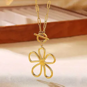 Gold hollow flower pendant necklace with OT clasp and chain link design, elegant jewelry detail.