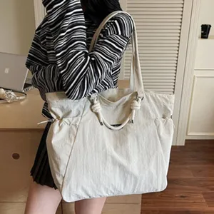 Large capacity canvas tote bag with rope handles and side pockets for women autumn fashion.
