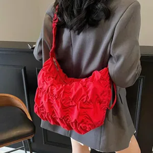 Red ruched shoulder bag detailed shot, stylish slouchy tote showcasing daily fashion wear style.
