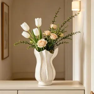 Close up of white ceramic art vase with floral arrangement, home entryway decor detail view
