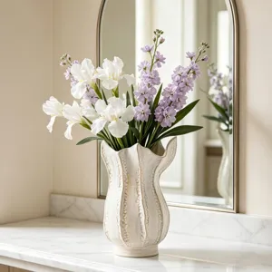 Modern white ceramic flower vase with artificial floral arrangement for home decor and entryway.