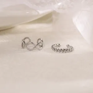 Detailed view of two silver geometric and spiral non-pierced ear cuffs, elegant design.