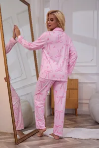 Women pink long sleeve button-down pajama set with cute bow and heart print for cozy sleepwear