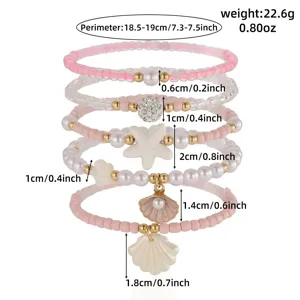 Detail view of summer beach beaded bracelet set, showing starfish and shell charm sizes.