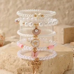 Summer beach style layered pearl bracelet set featuring cute starfish and seashell charms.