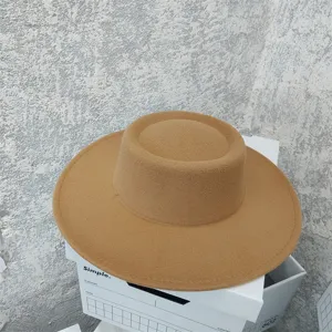 Close-up detail of a classic camel flat-top wide-brim felt hat, retro autumn winter style.